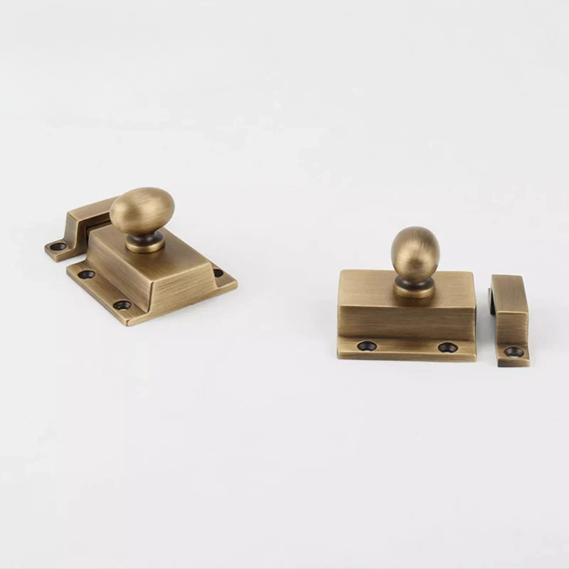 Three brass door handles on a white background