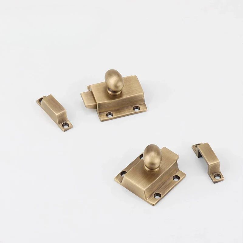 Set of brass door handles and latches on a white background