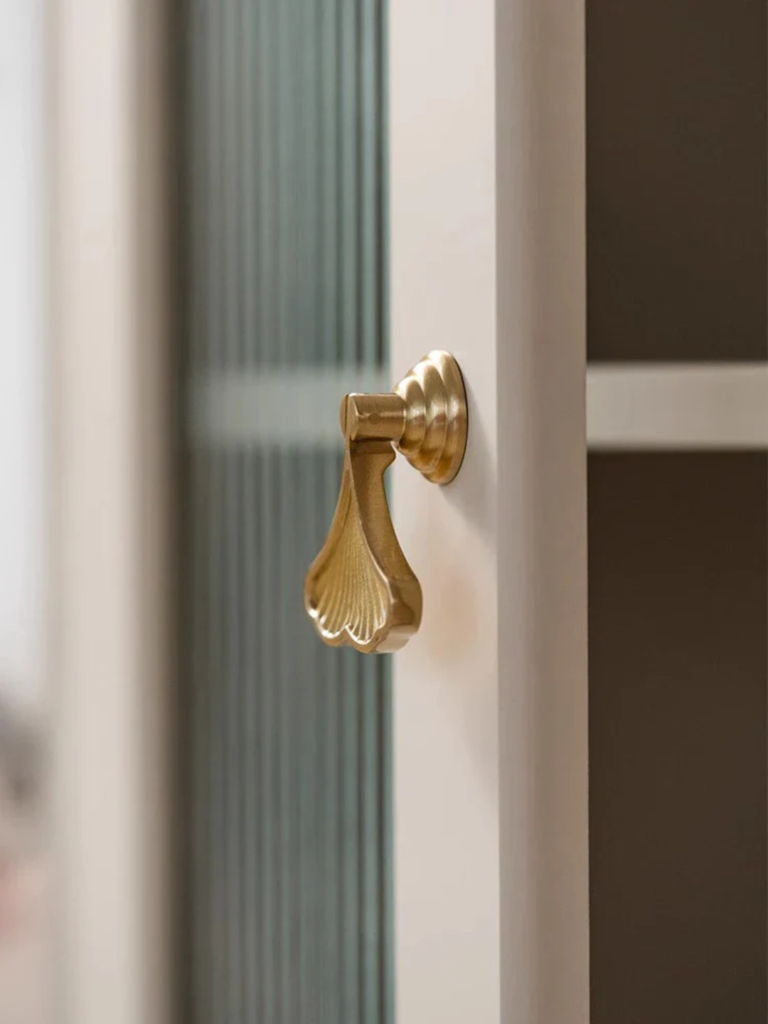 Gold door handle on a glass door