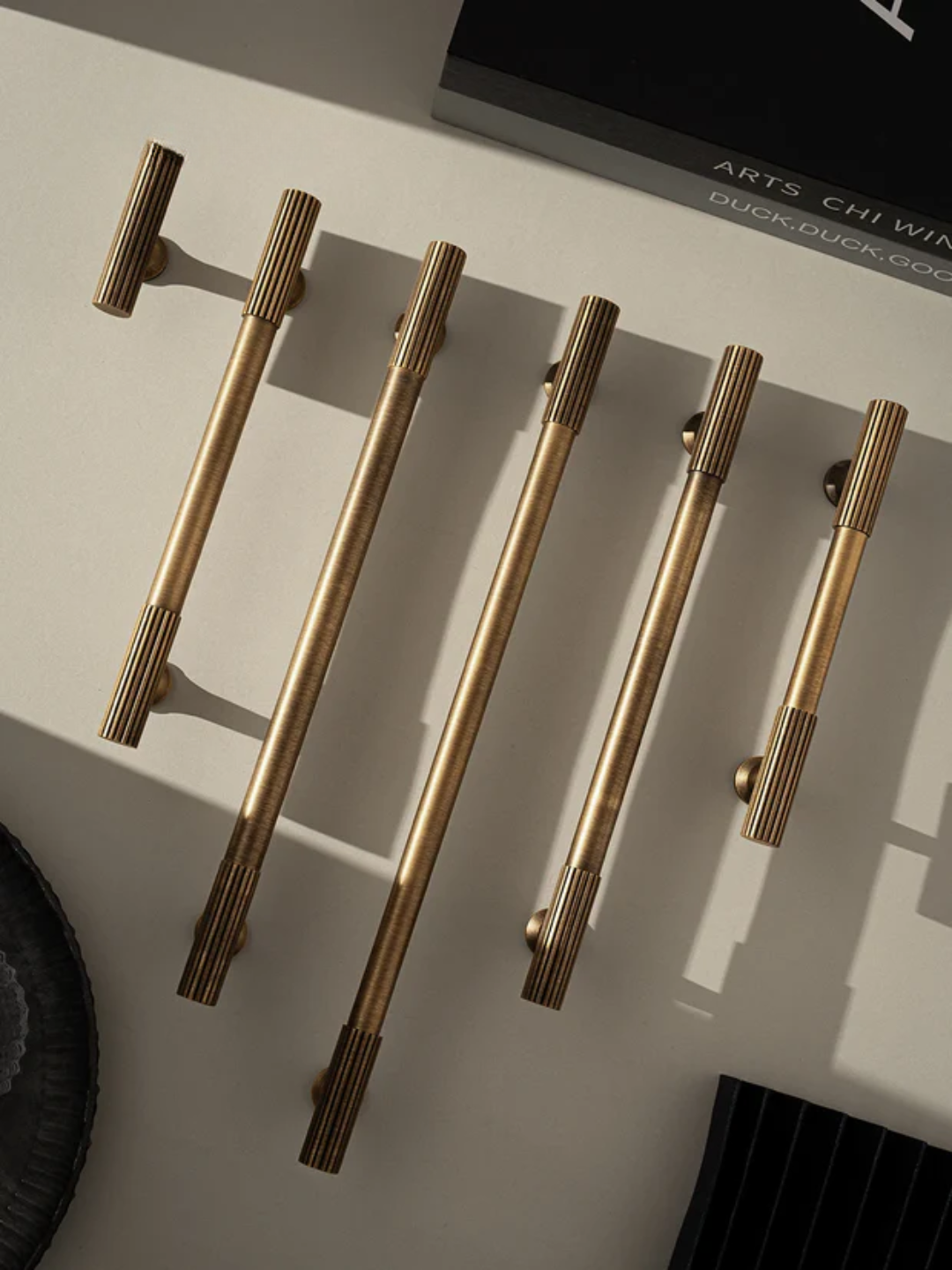 Set of gold cabinet handles on a light surface