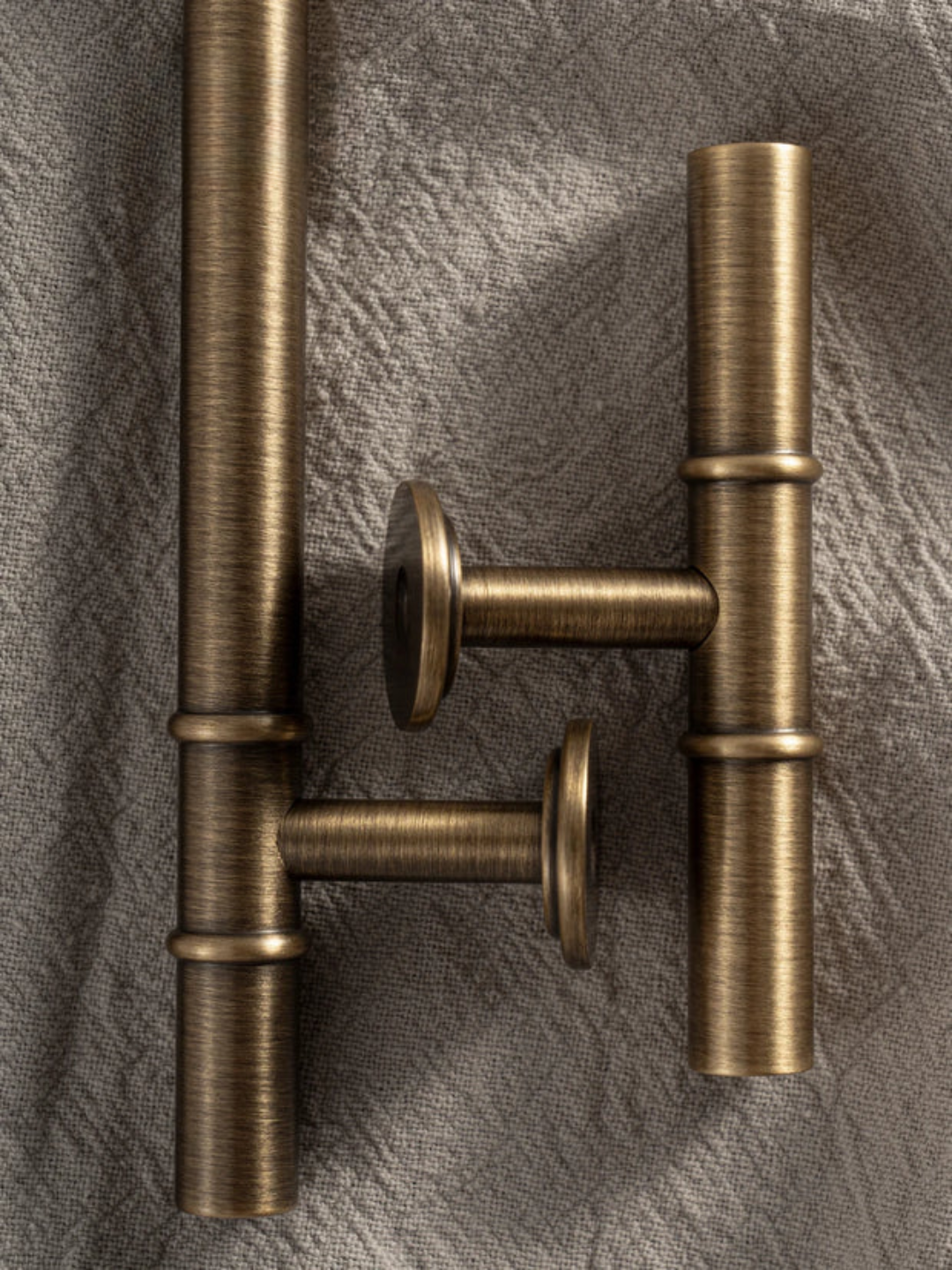 Bronze door handle on a textured gray background