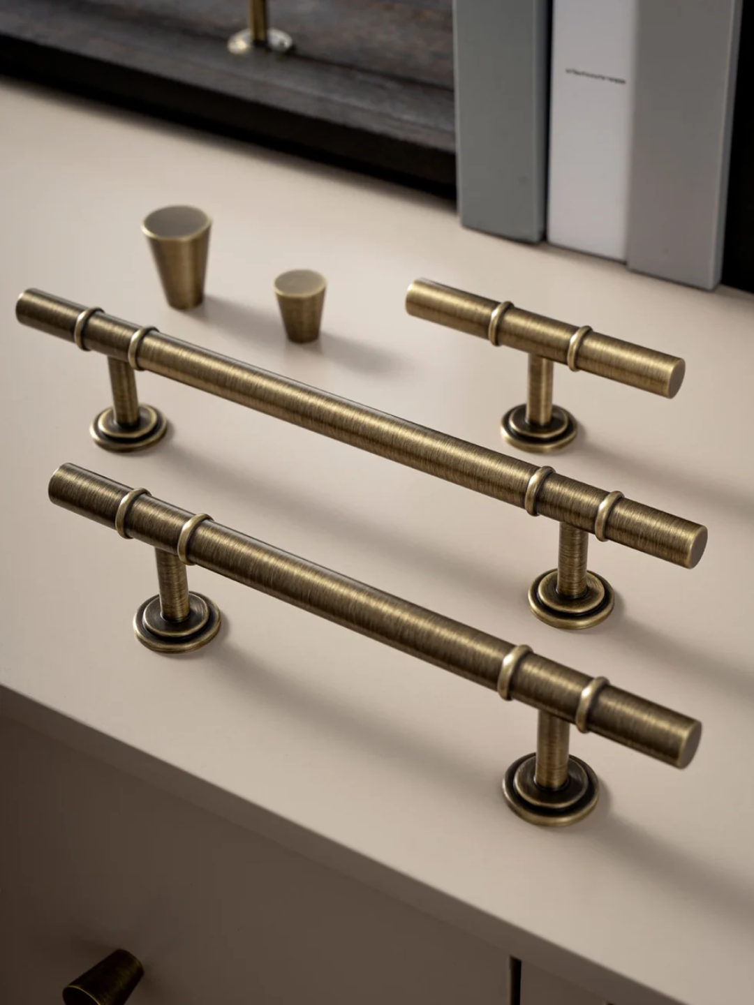 Brass cabinet handles on a white surface with 'Santaya' branding.