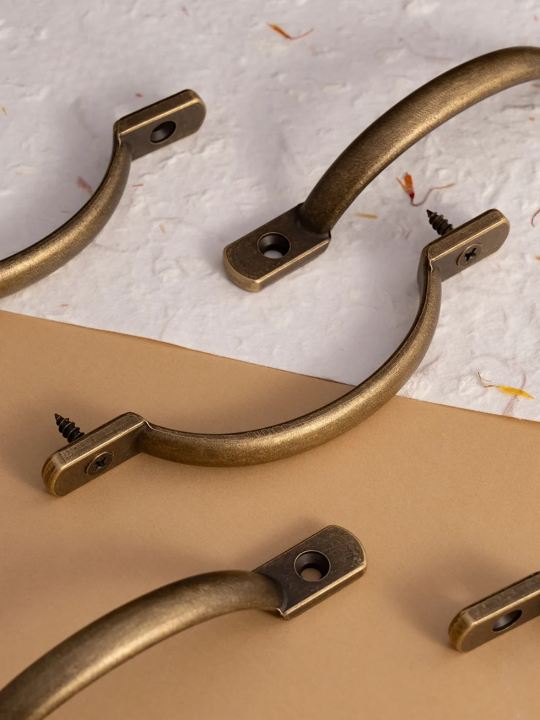 Bronze window handles on a textured surface