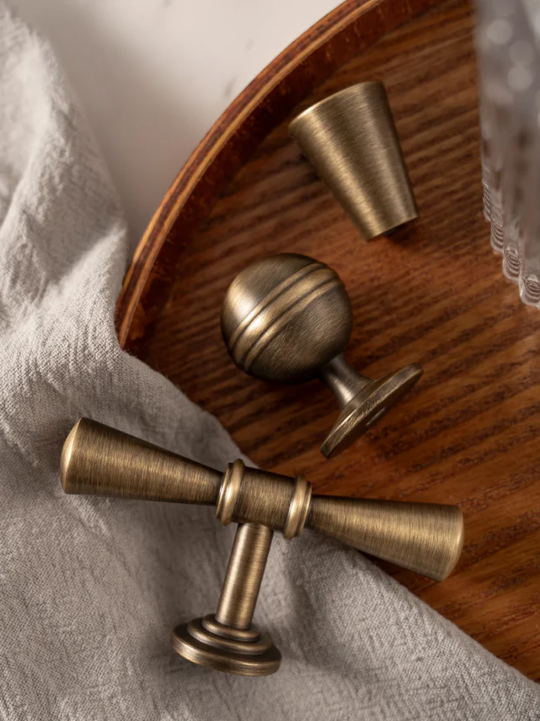 Brass door handles on a wooden surface with 'Santaya' branding.