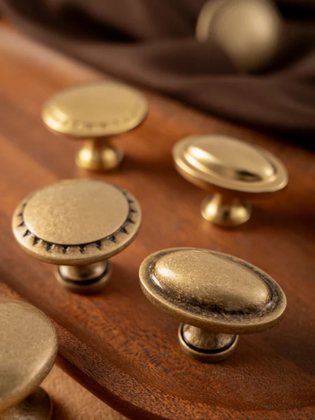 Set of brass cabinet knobs on a wooden surface
