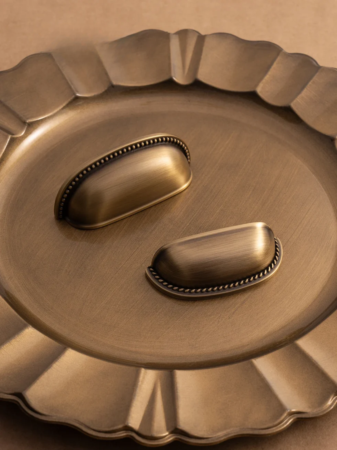 Decorative bronze door handle on a bronze background