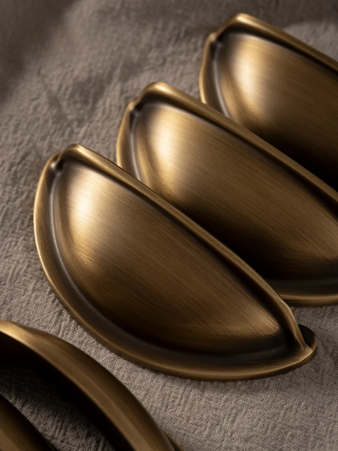 Bronze cabinet handles on a textured surface