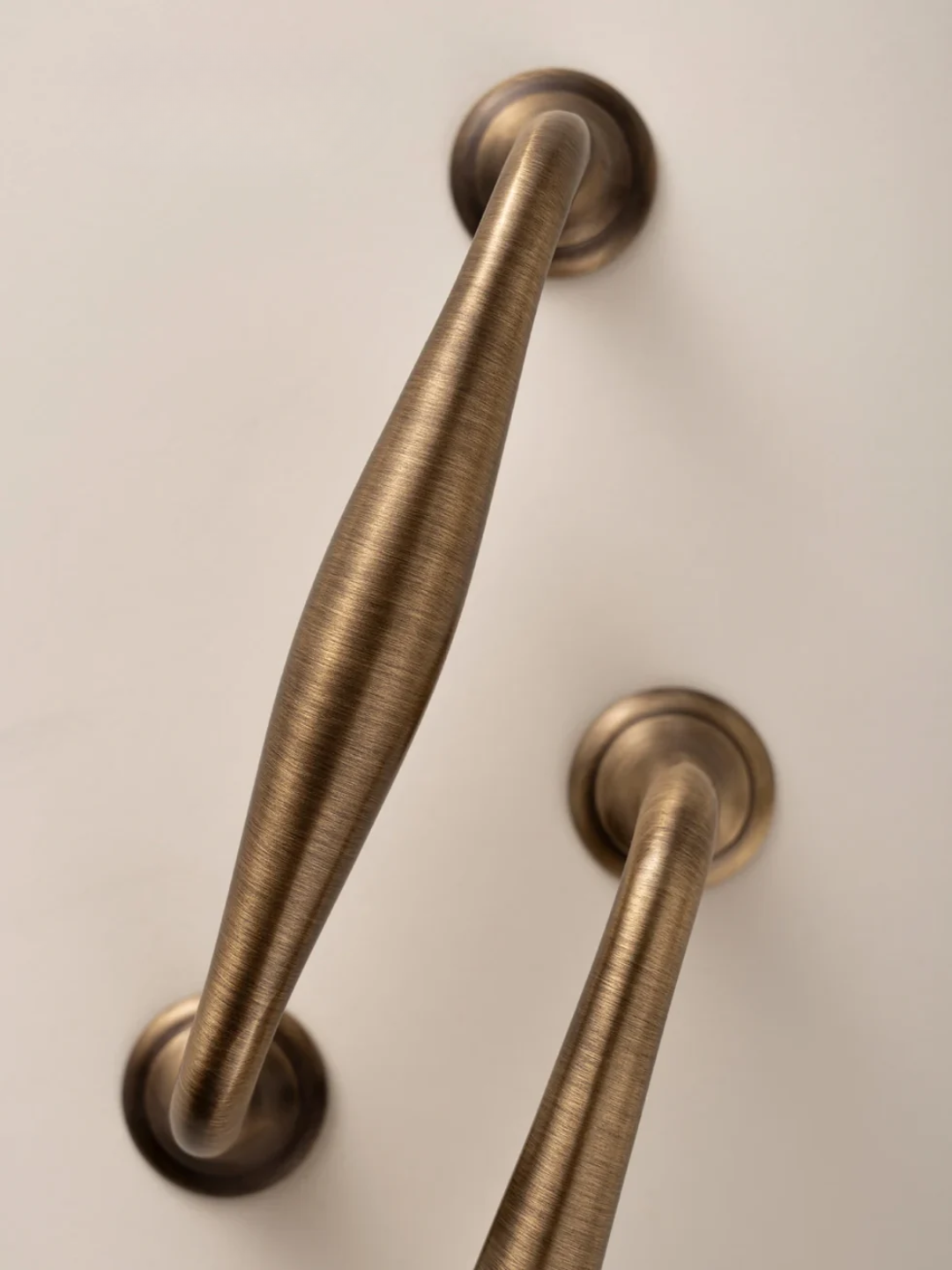 Pair of bronze handles on a white door with 'Santaya' branding.