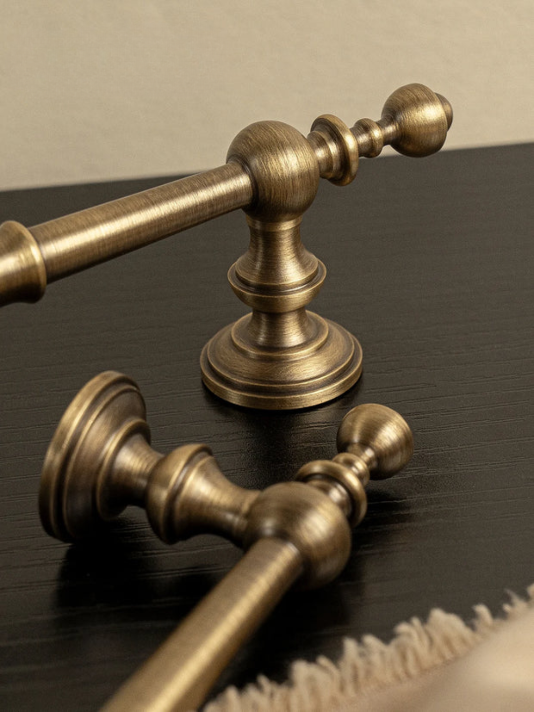 Brass towel bar set on a dark surface with 'Santaya' branding.