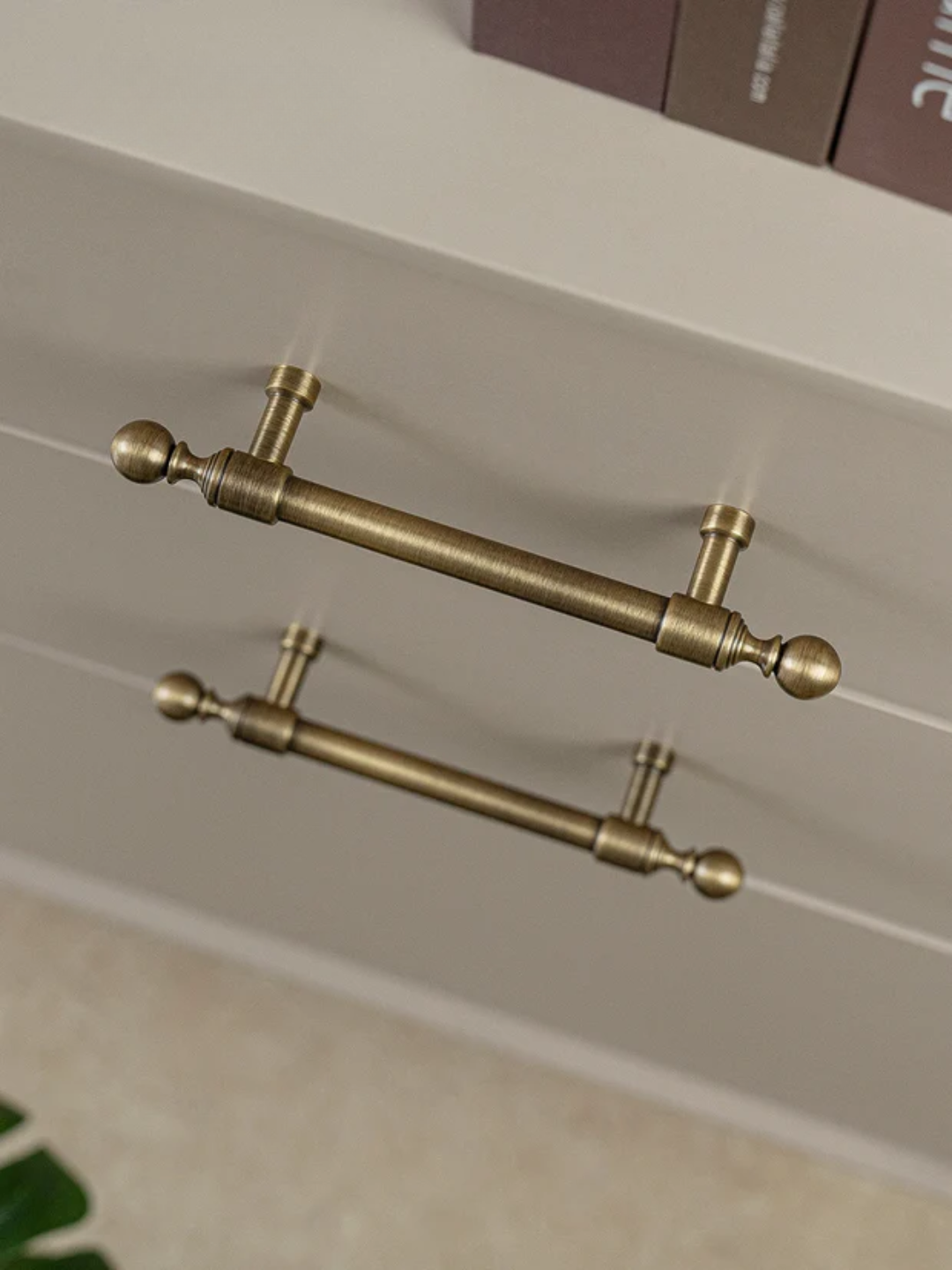 Pair of gold handles on a neutral background