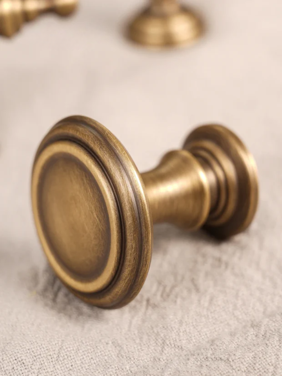 Brass cabinet knob on a textured surface with 'Santaya' branding.