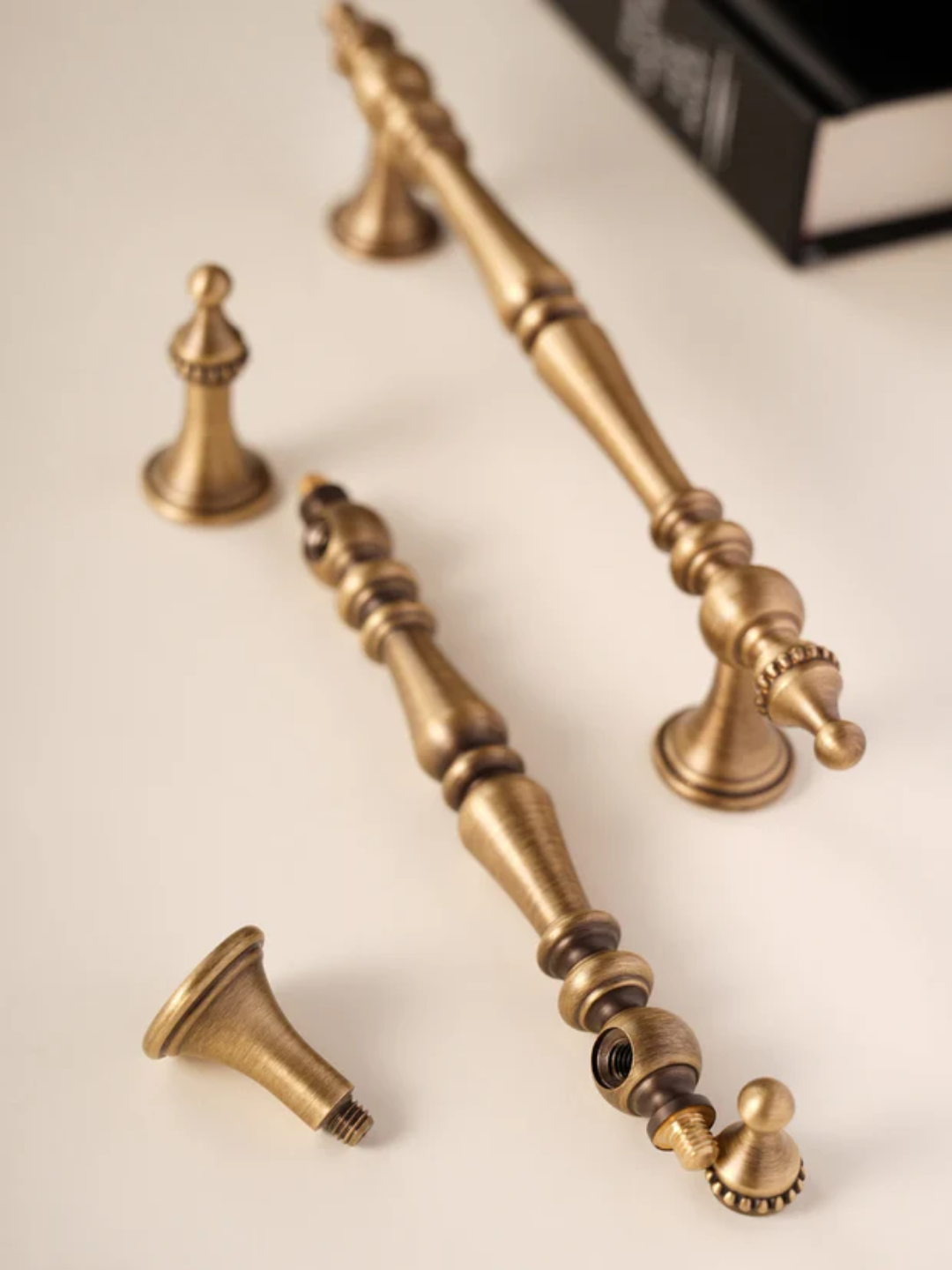 Set of ornate brass hardware components on a light background