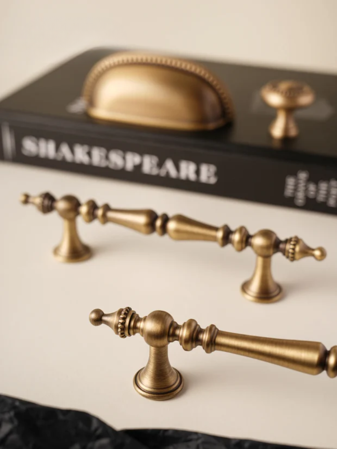 Set of gold cabinet handles on a neutral background
