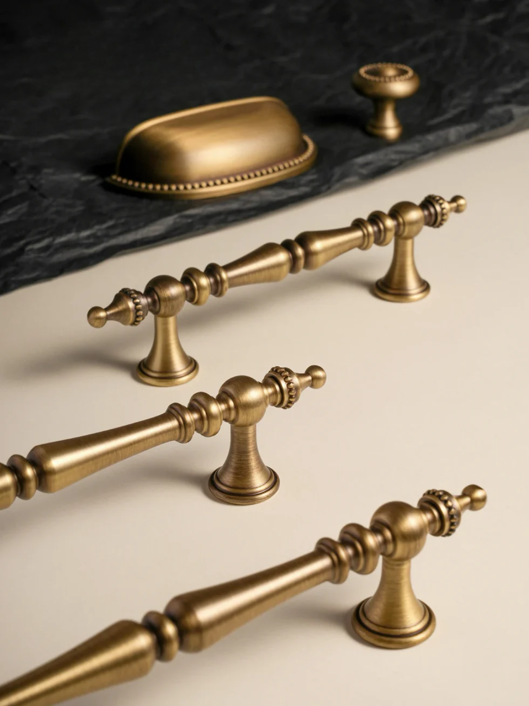 Set of gold cabinet handles on a neutral background