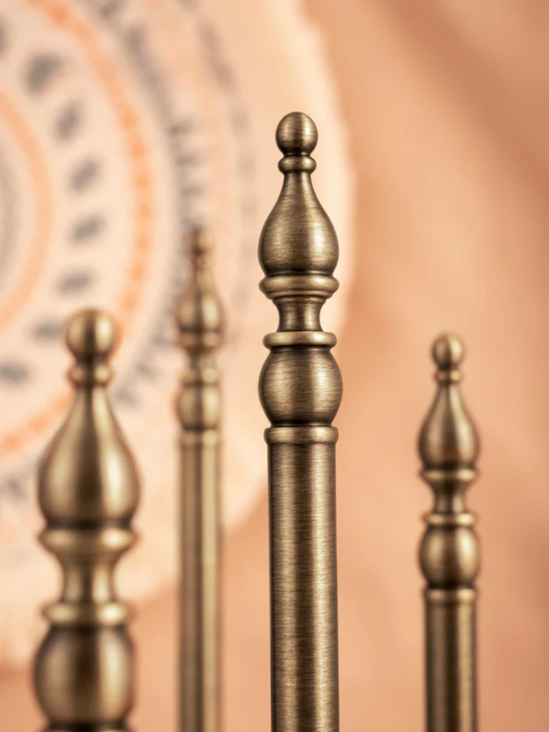 Close-up of decorative metal finials on a blurred background
