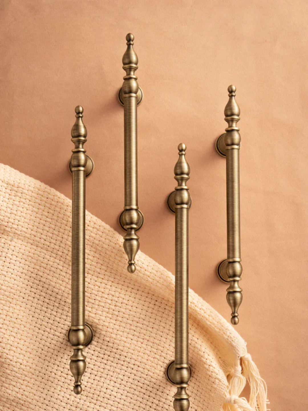 Set of decorative bronze rods on a textured surface