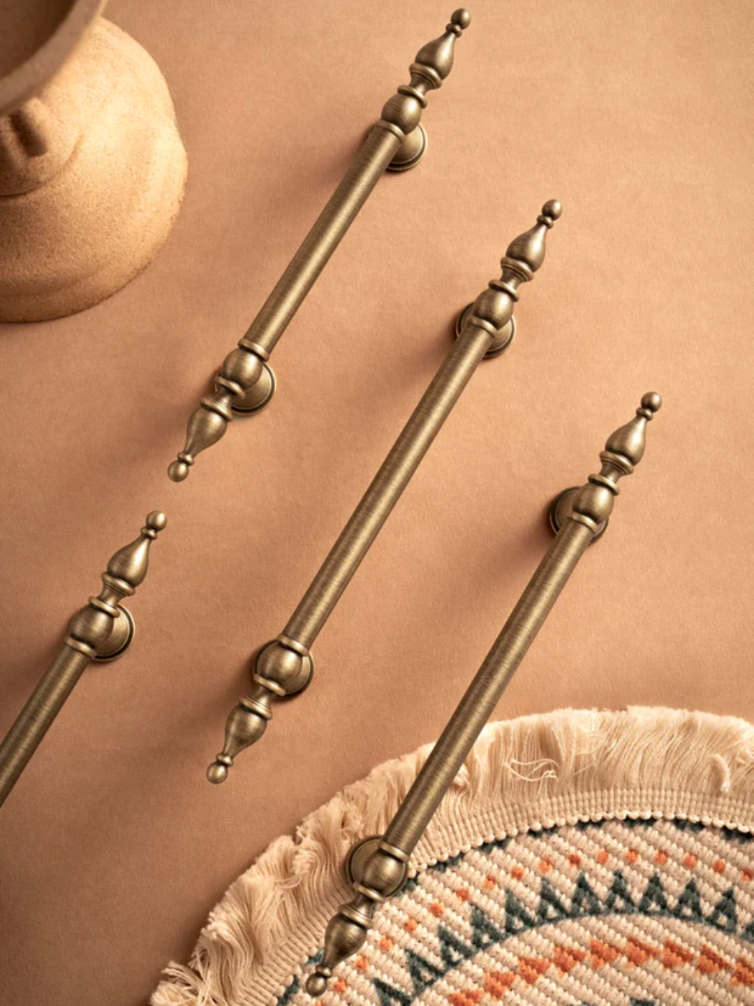 Set of decorative bronze rods on a textured surface