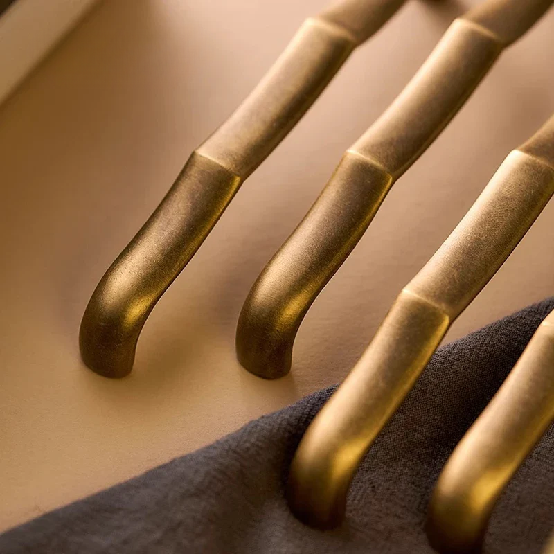 Close-up of gold metal handles on a dark surface