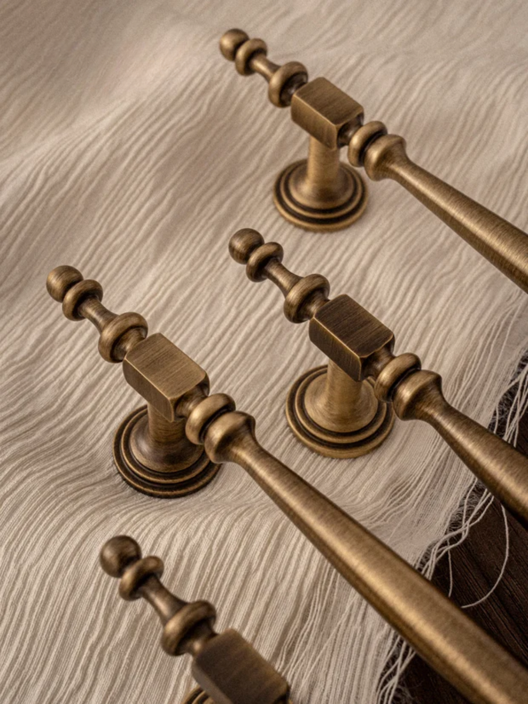 Bronze door handles on a wooden surface with 'Santaya' branding.
