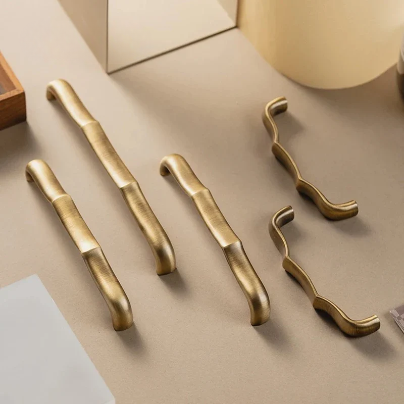 Set of gold cabinet handles on a neutral background