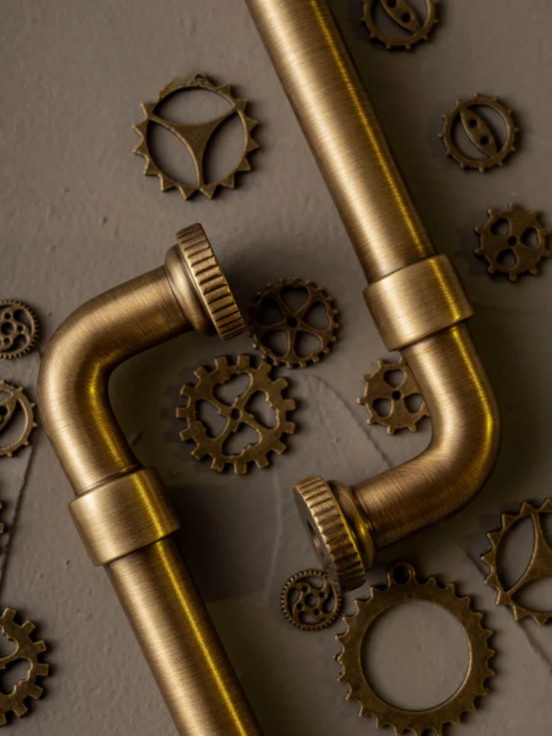 Bronze pipes and gears on a textured surface