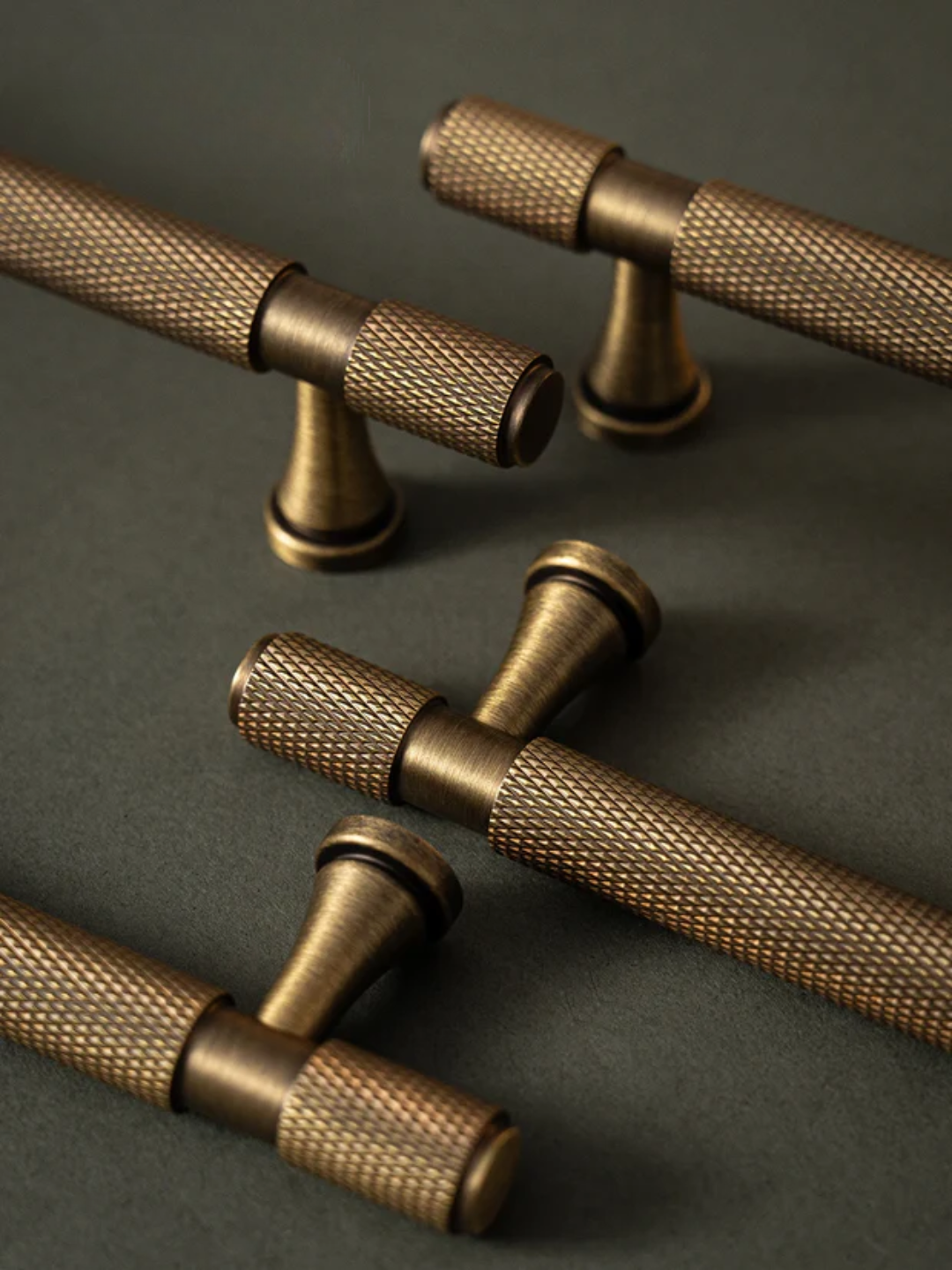 Bronze door handles on a dark surface