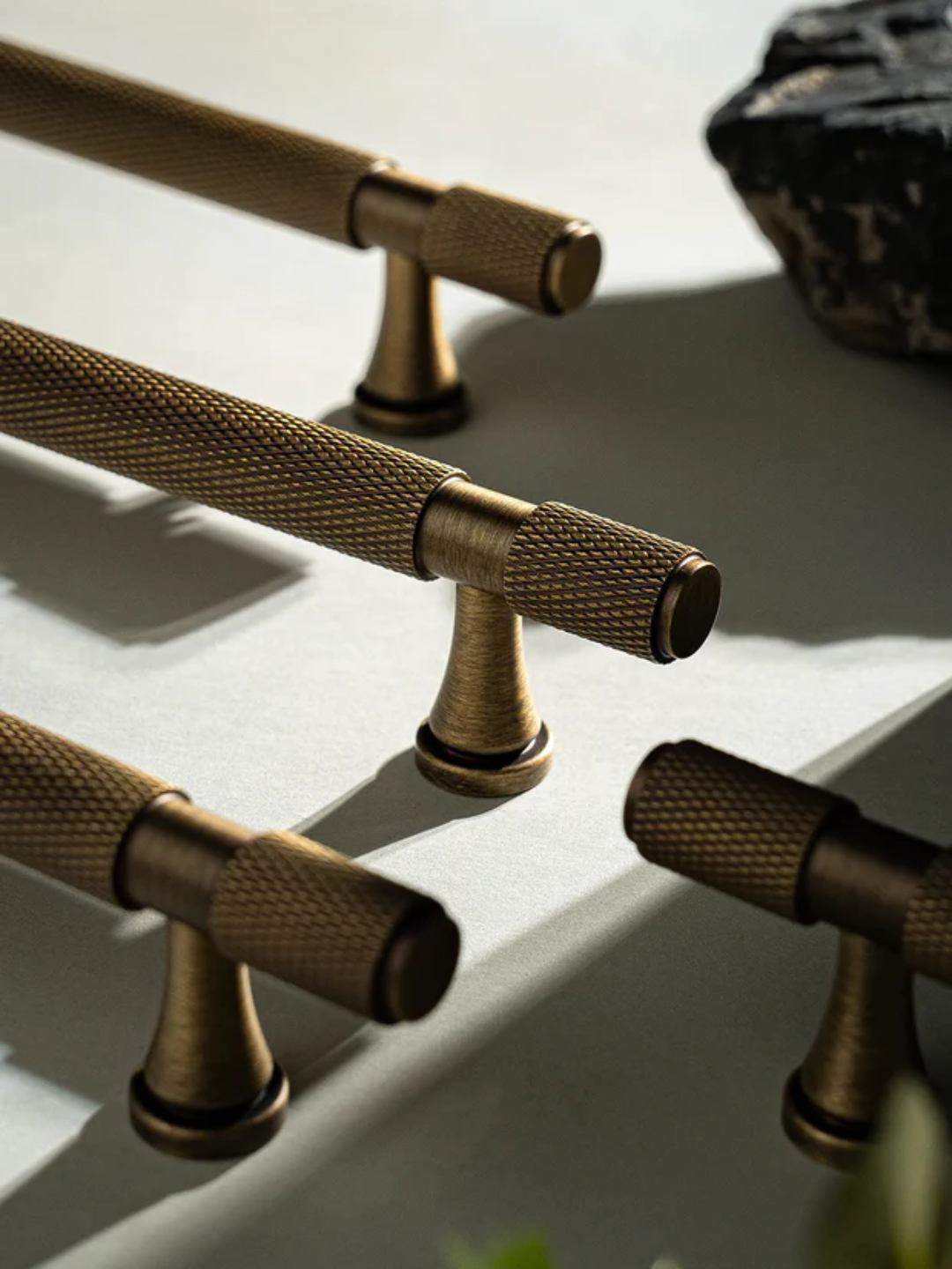 Brass hardware handles on a light background with 'Santaya' branding.