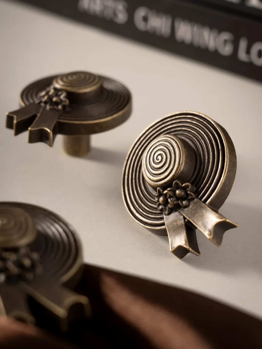 Close-up of decorative bronze buttons on a white surface