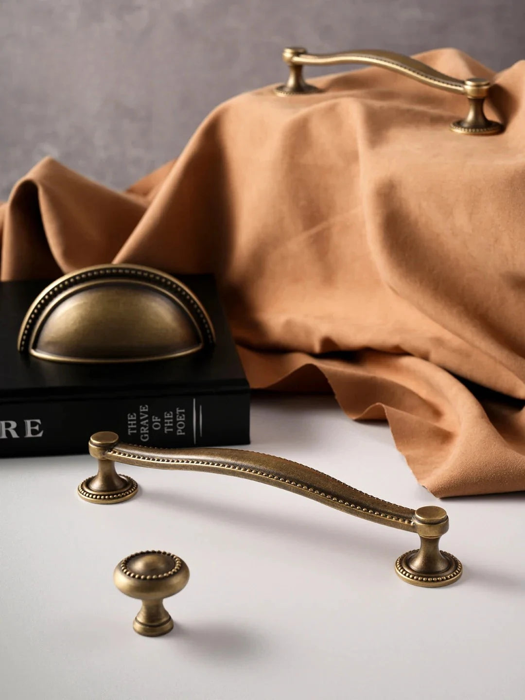 Vintage-style brass handles on a neutral background