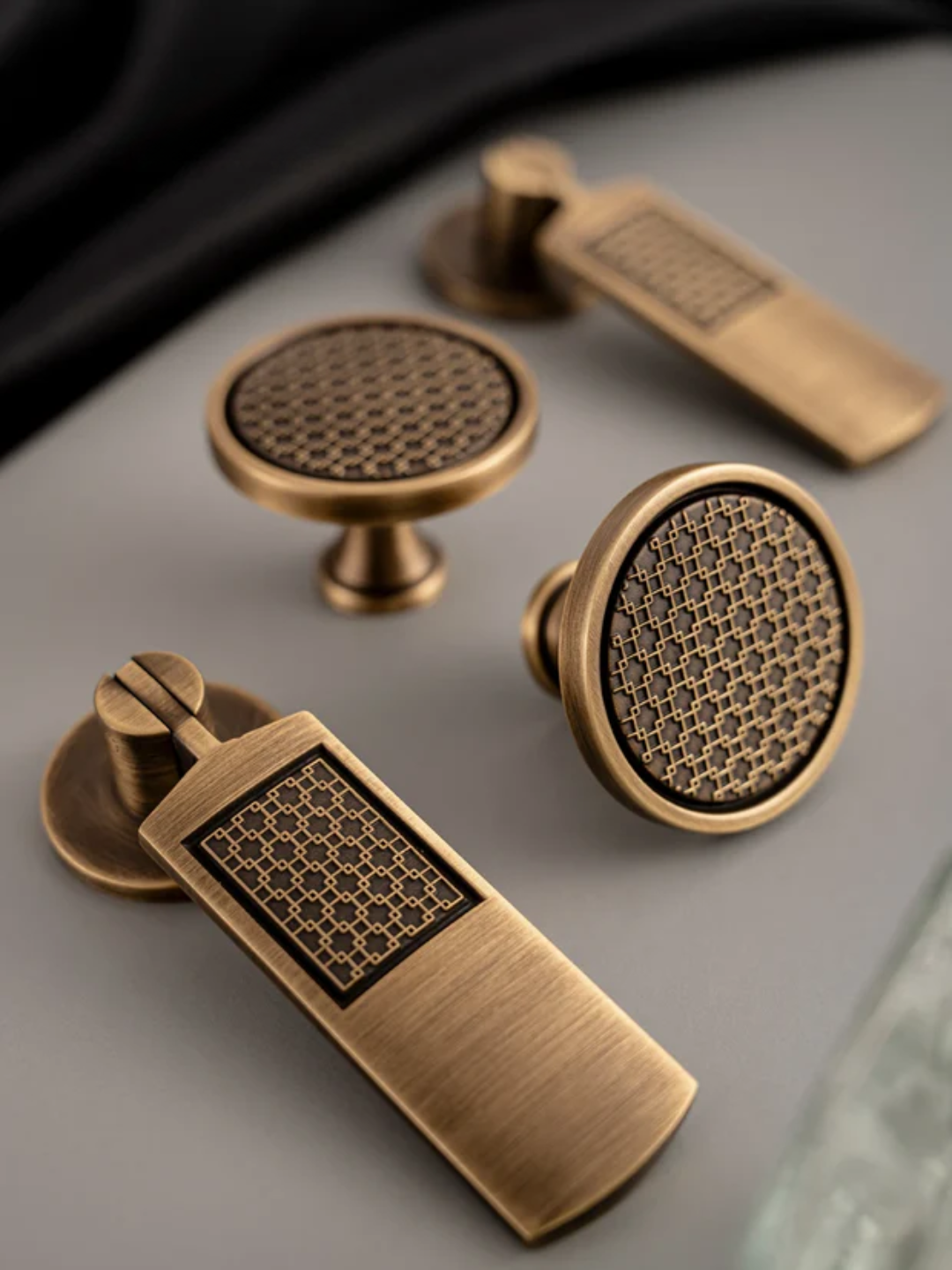 Set of bronze cabinet knobs on a gray surface
