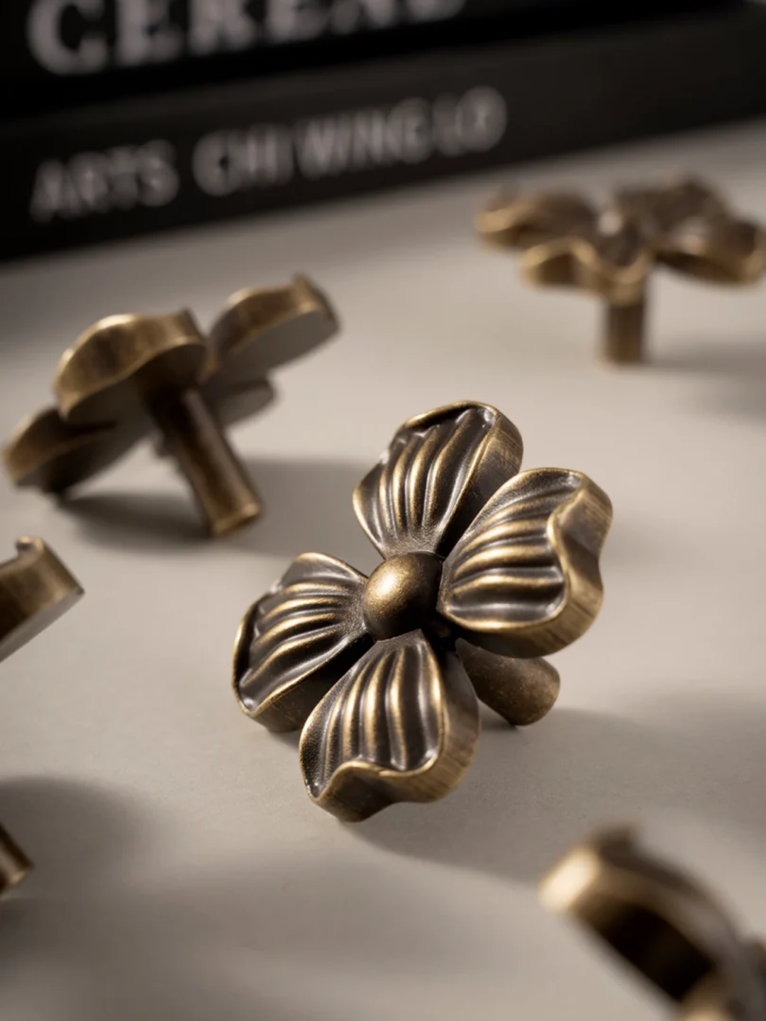 Bronze floral decorative elements on a neutral background