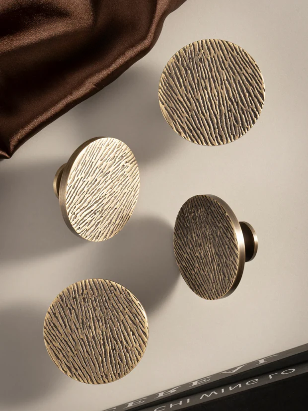 Set of bronze cabinet knobs on a neutral background