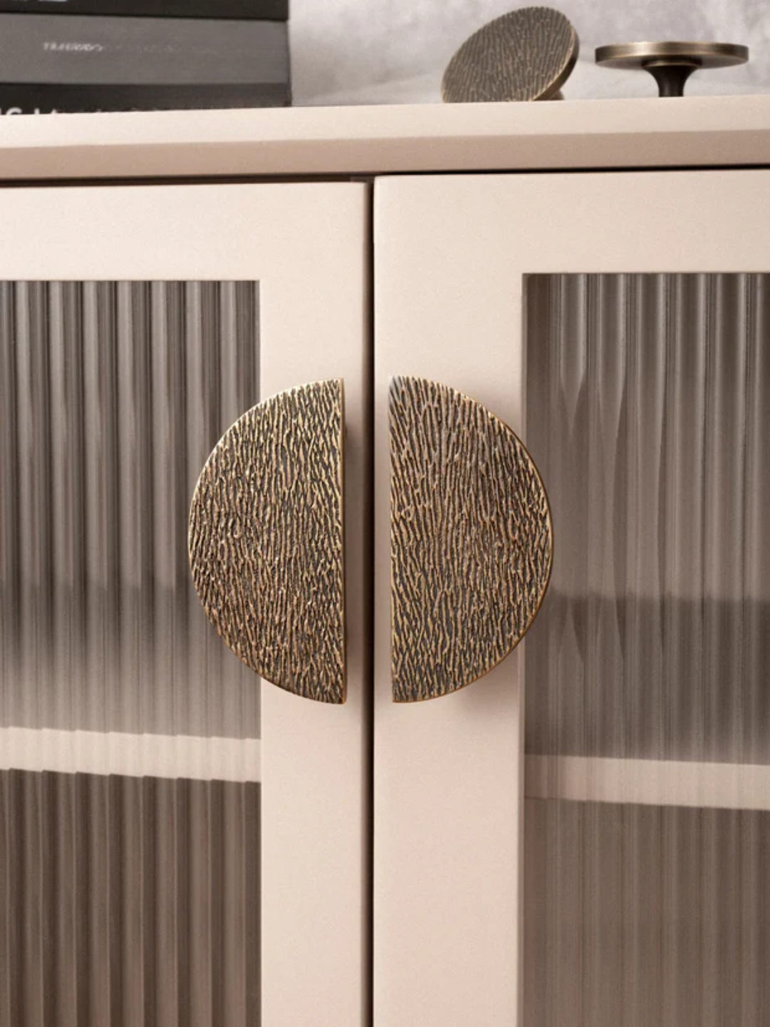 Close-up of a cabinet with decorative round handles on a blurred background