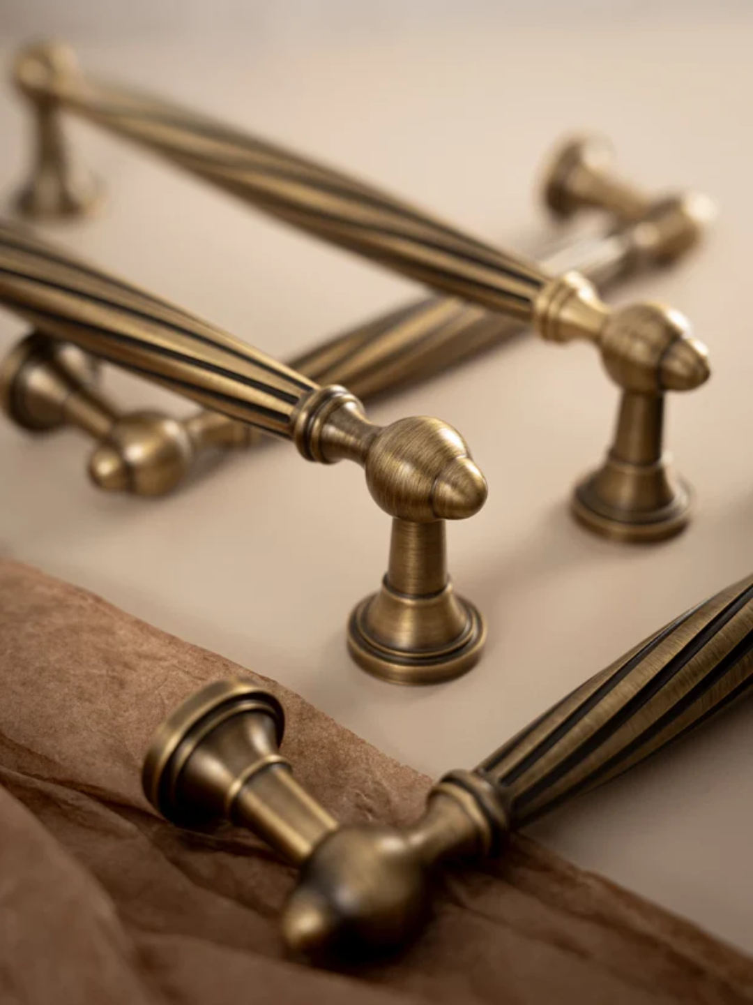Brass hardware fixtures on a neutral background