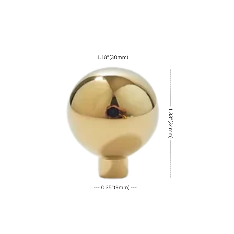 Gold spherical object with measurements on a white background