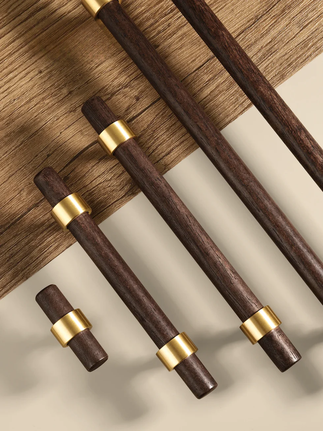 Set of wooden chopsticks with gold bands on a wooden surface