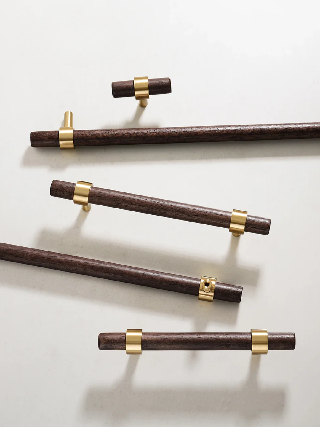 Wooden rods with gold connectors on a light gray background
