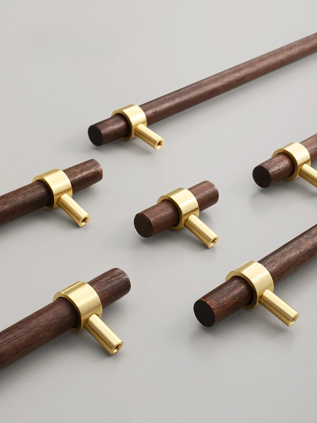 Wooden rods with gold connectors on a light gray background