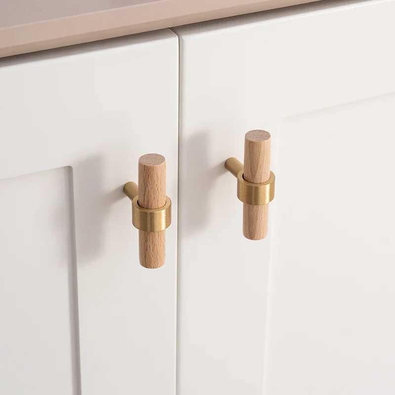 Cabinet doors with brass and wooden handles on a white background