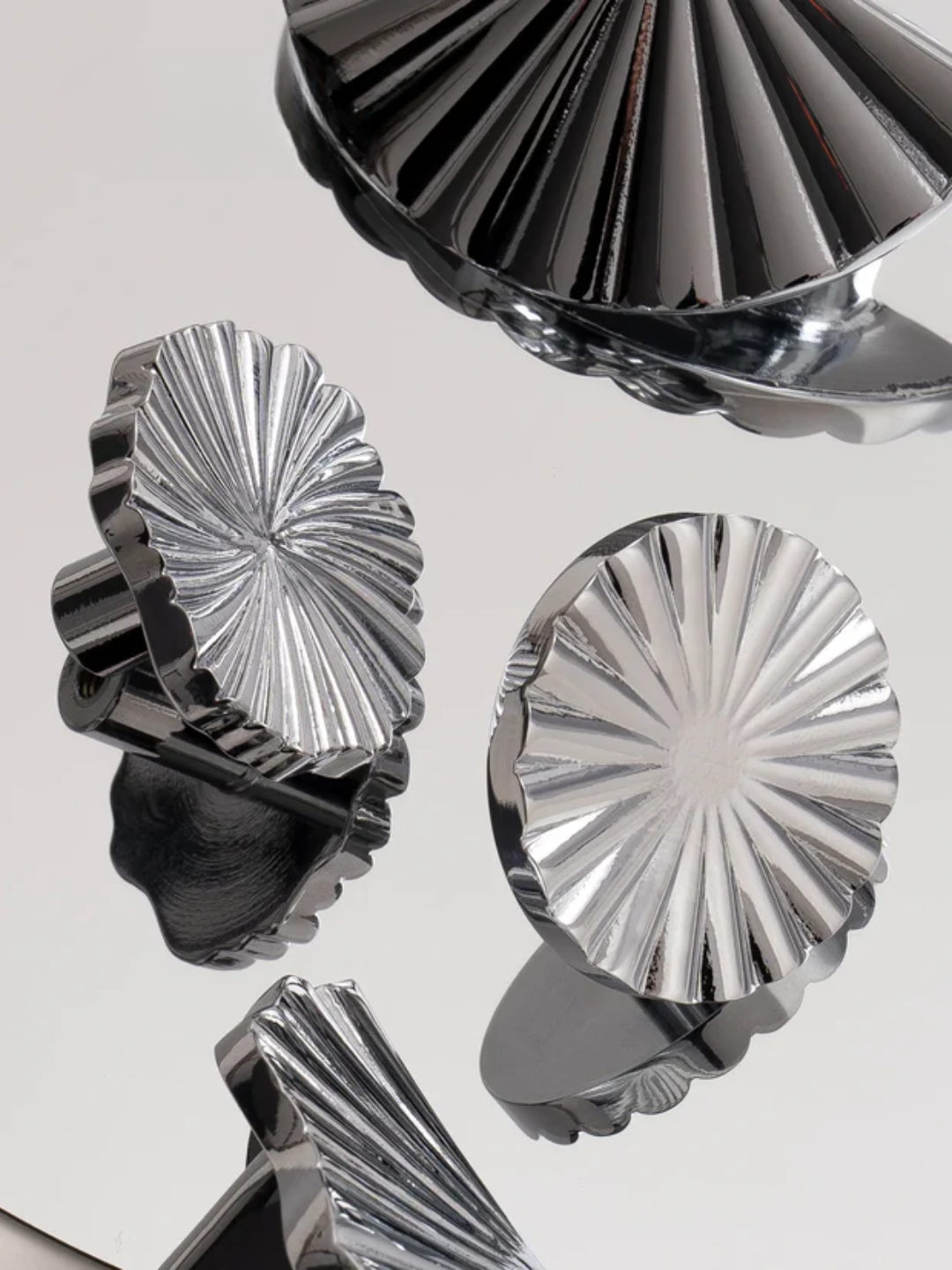 Metallic decorative elements with sunburst patterns on a reflective surface