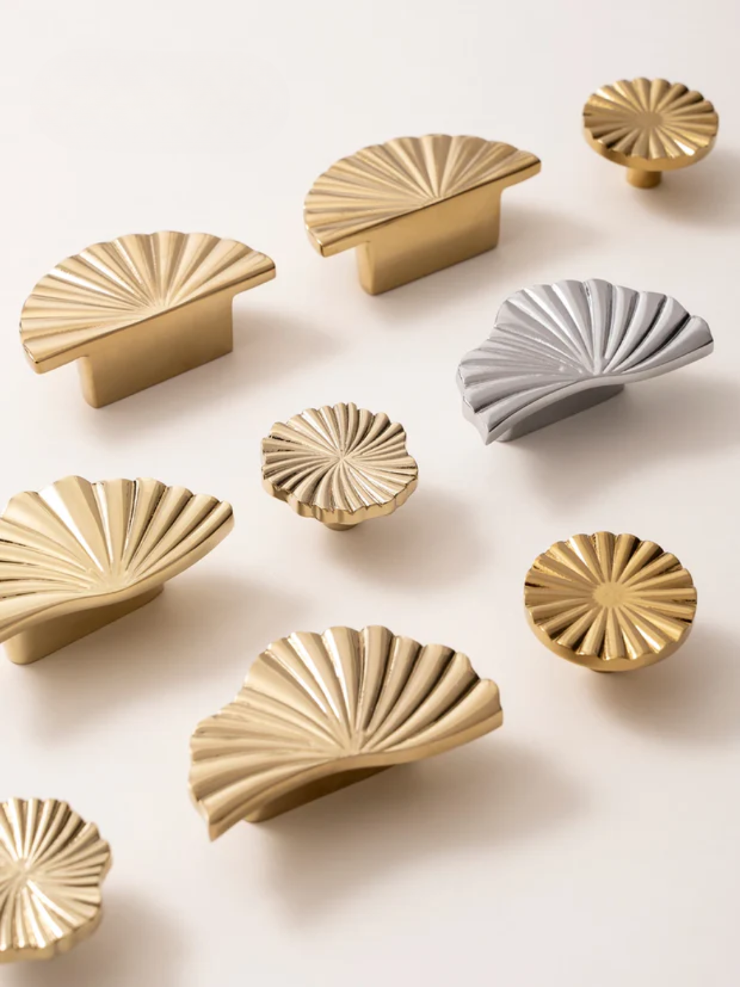 Gold and gray decorative knobs on a light beige background
