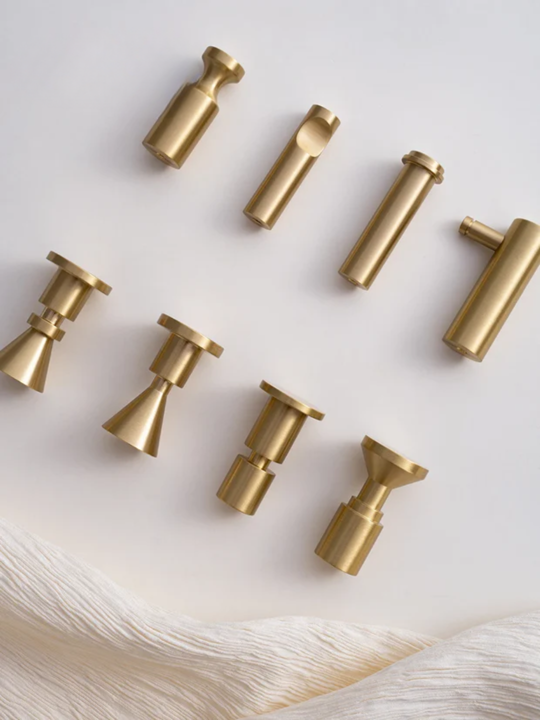 Set of gold curtain rods on a white background