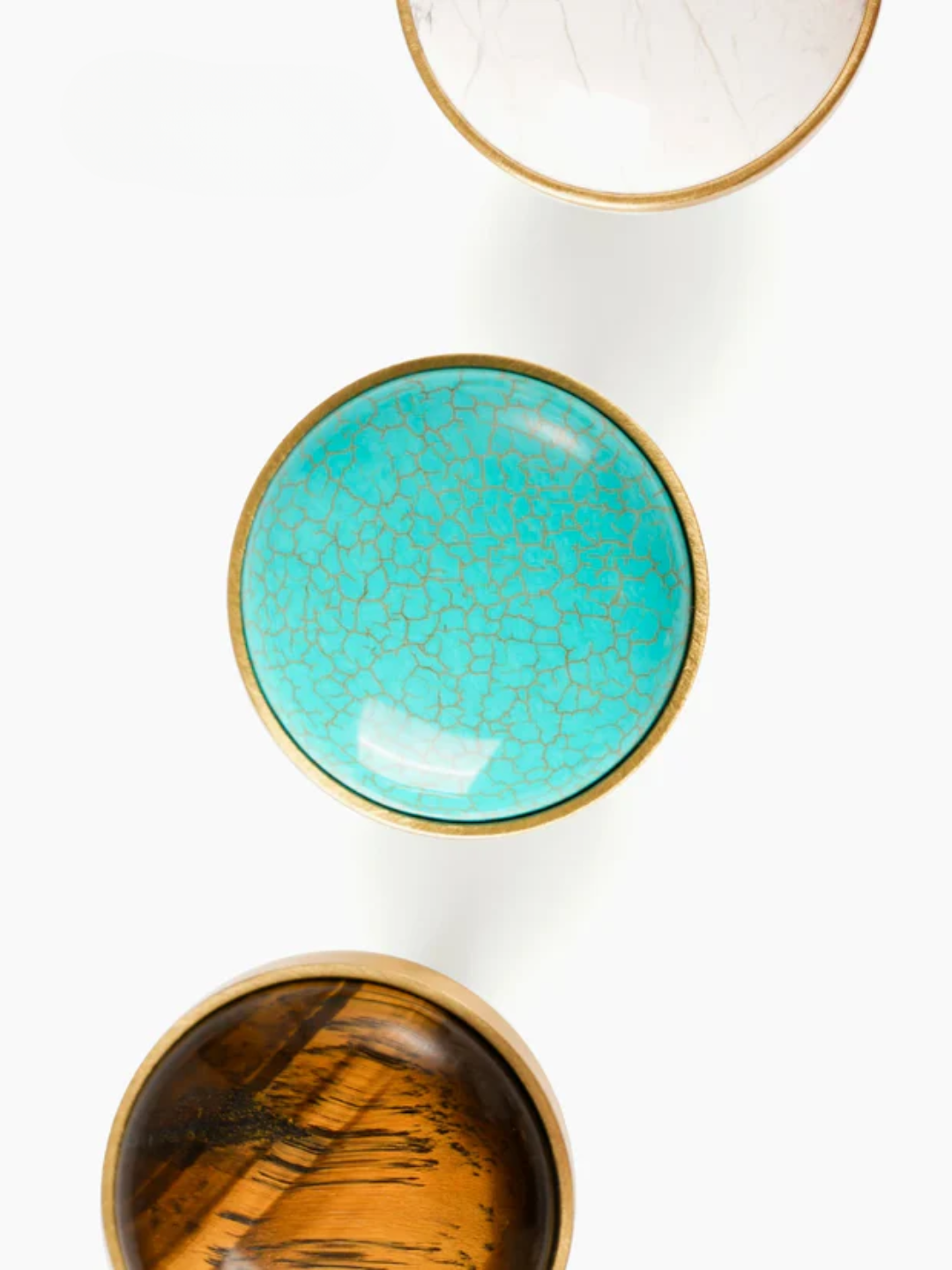 Three ceramic bowls with different finishes on a white background