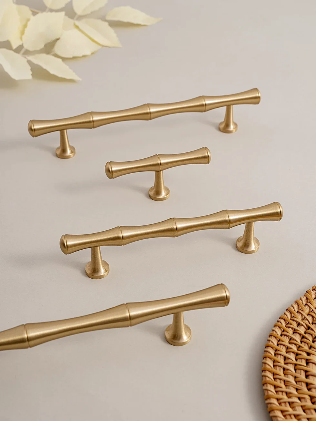 Gold cabinet handles on a light background with 'Santaya' branding.