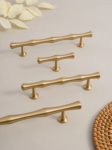 Gold cabinet handles on a light background with 'Santaya' branding.