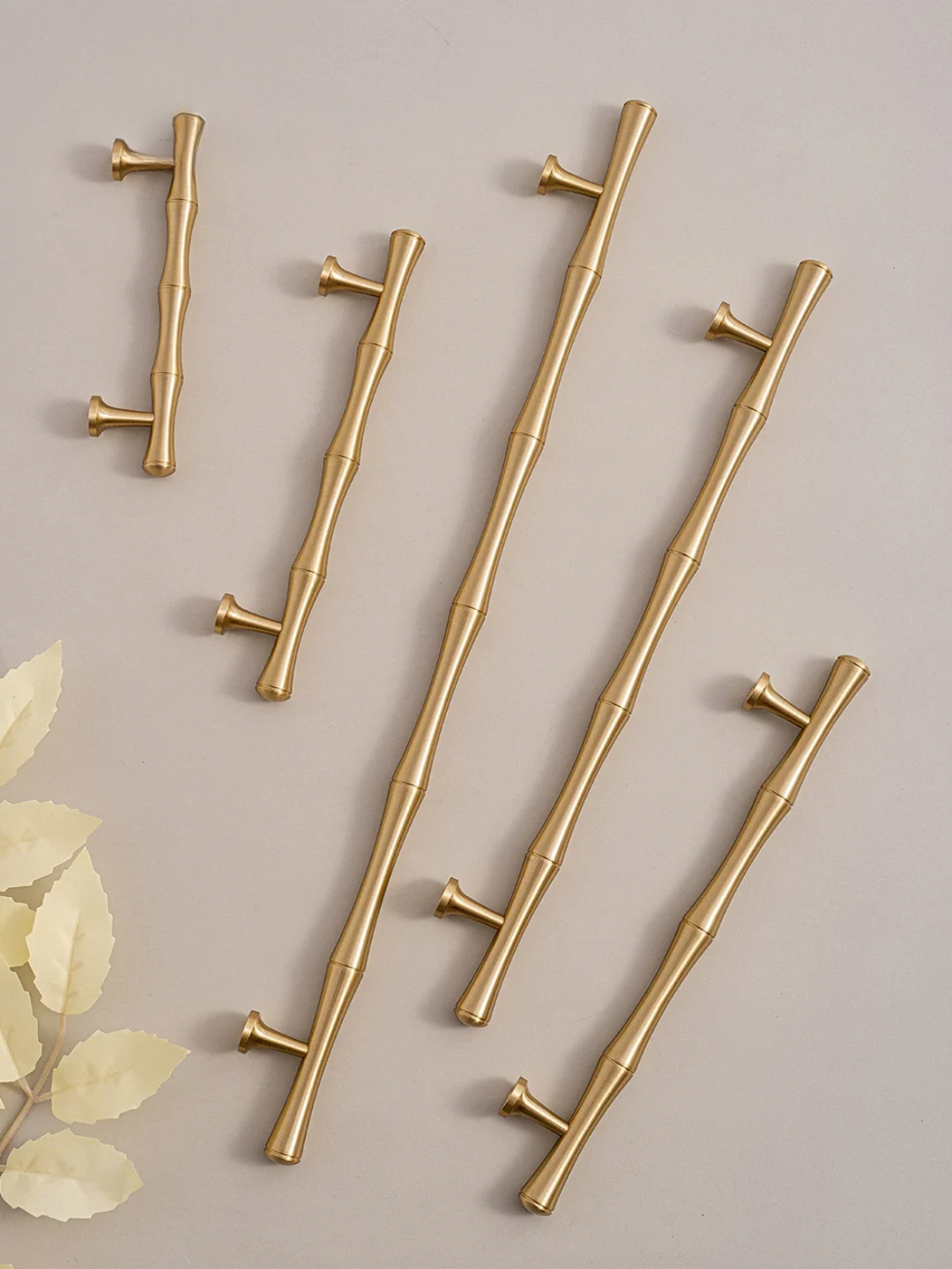 Set of gold cabinet handles with a neutral background