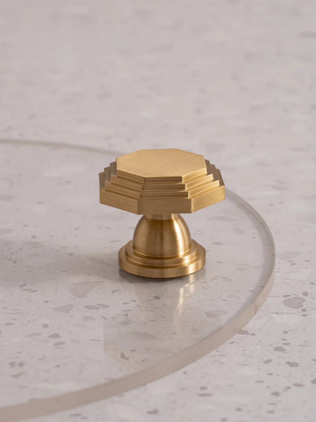 Gold hexagonal knob on a marble surface