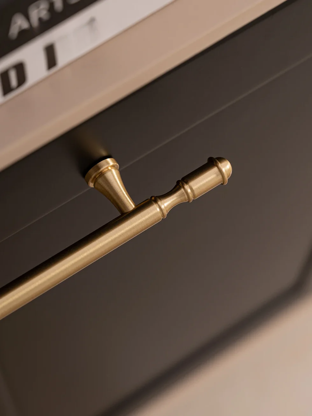 Close-up of a gold handle on a dark surface