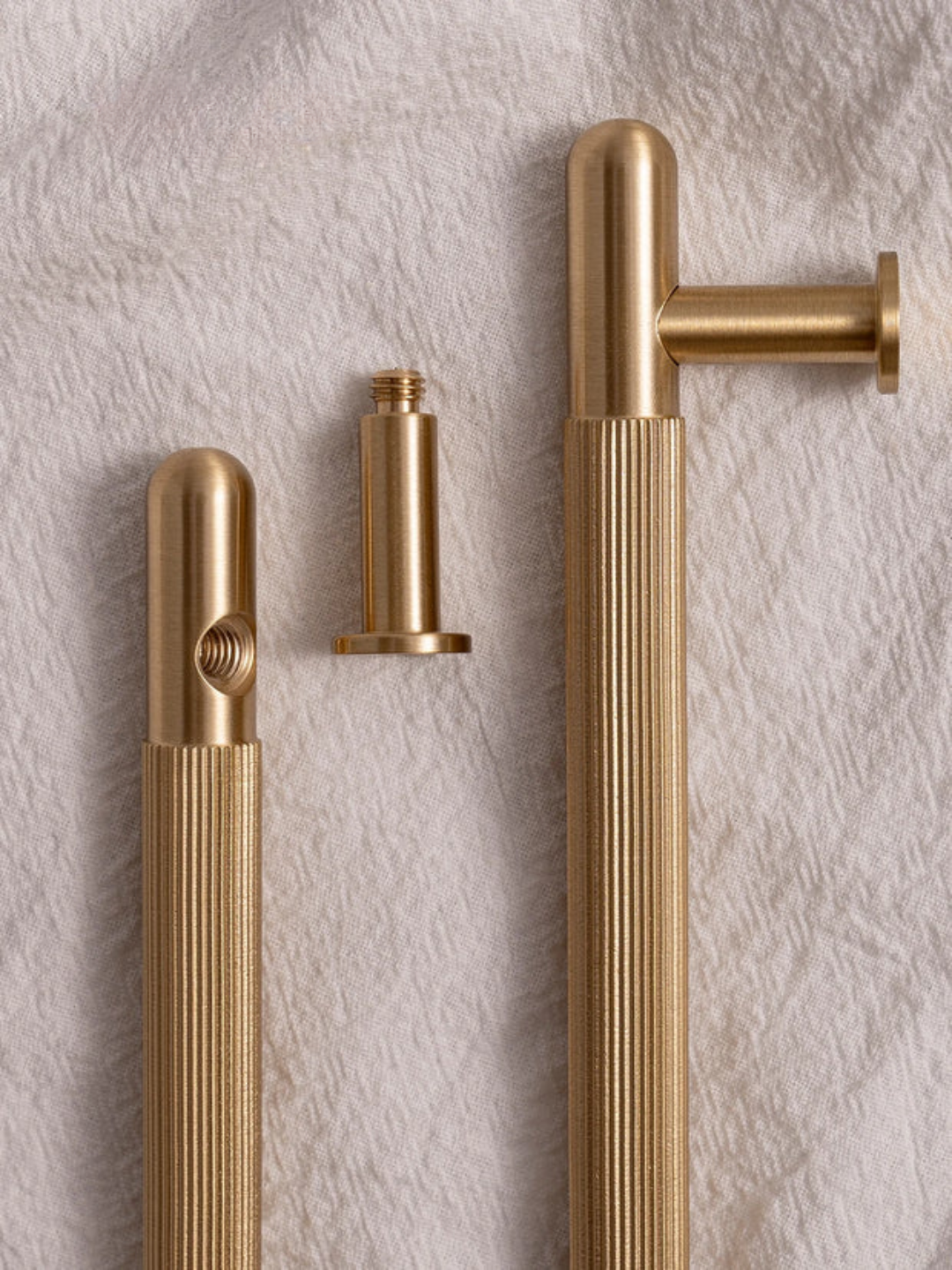Gold door handles on a textured wall