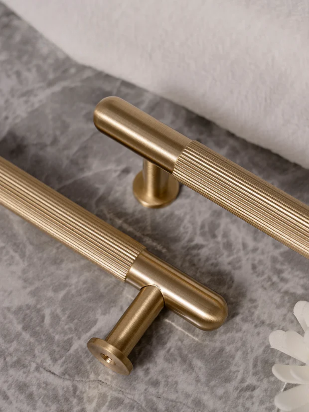 Gold cabinet handles on a marble surface
